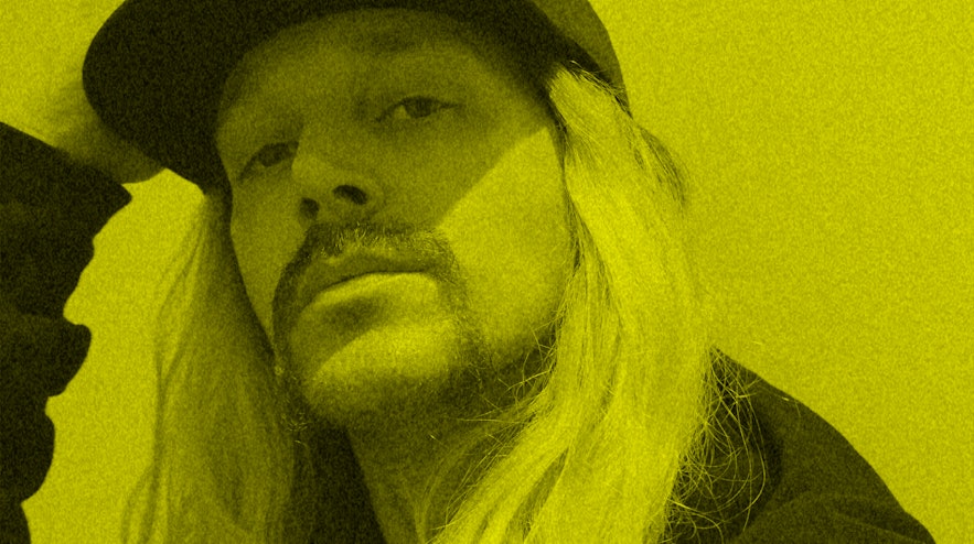 Person with long blonde hair sitting.