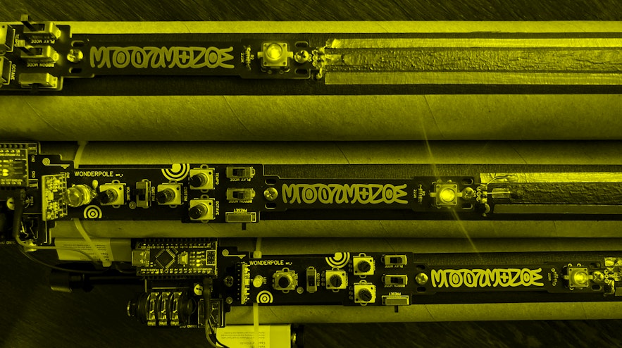 Three tubes on a table, lying next to eachother