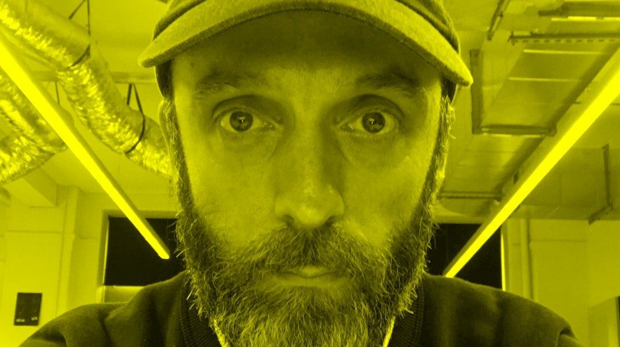 Close up selfie of a person in a cap and dark pullover