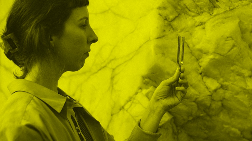 Person pictured from the side looking at a tuning fork